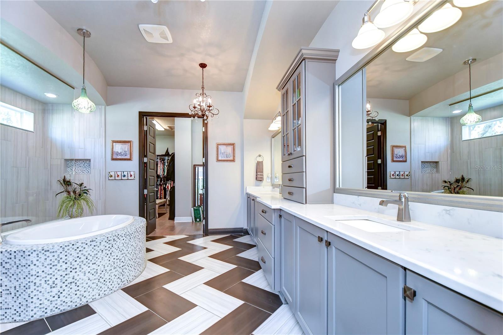 Primary bath with gorgeous herringbone tiles and dual sinks!