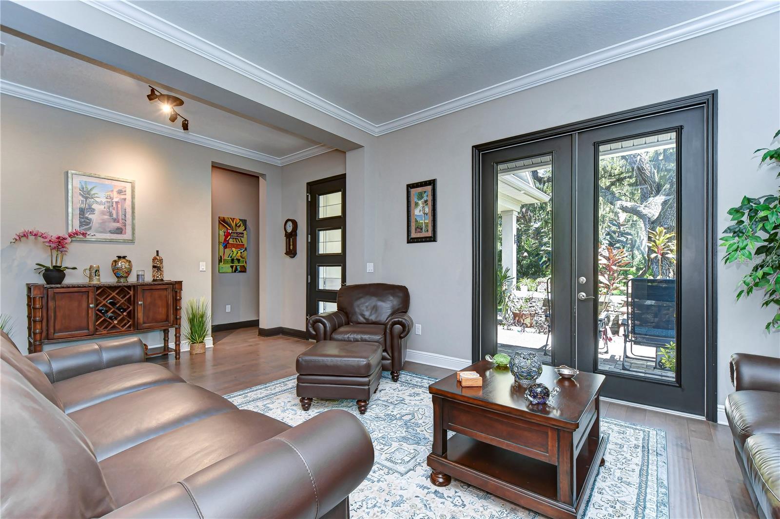 Formal living space welcomes you into this home with French doors to soak in the view.