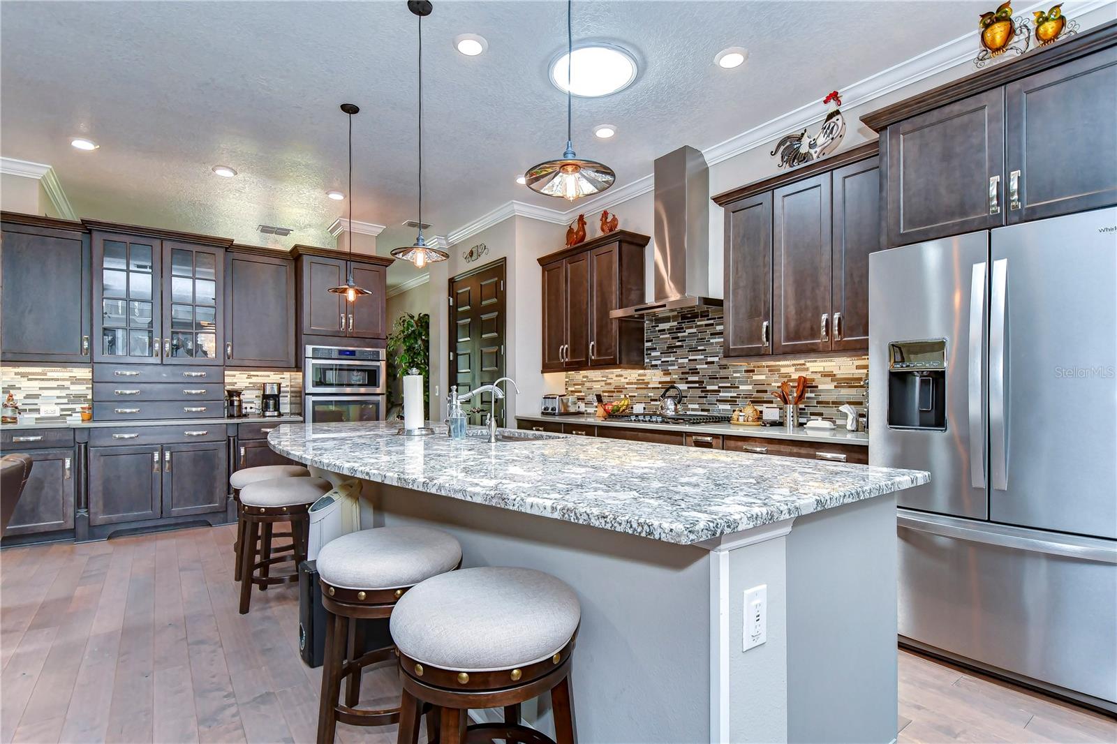 Large breakfast bar highlighted by statement lighting.