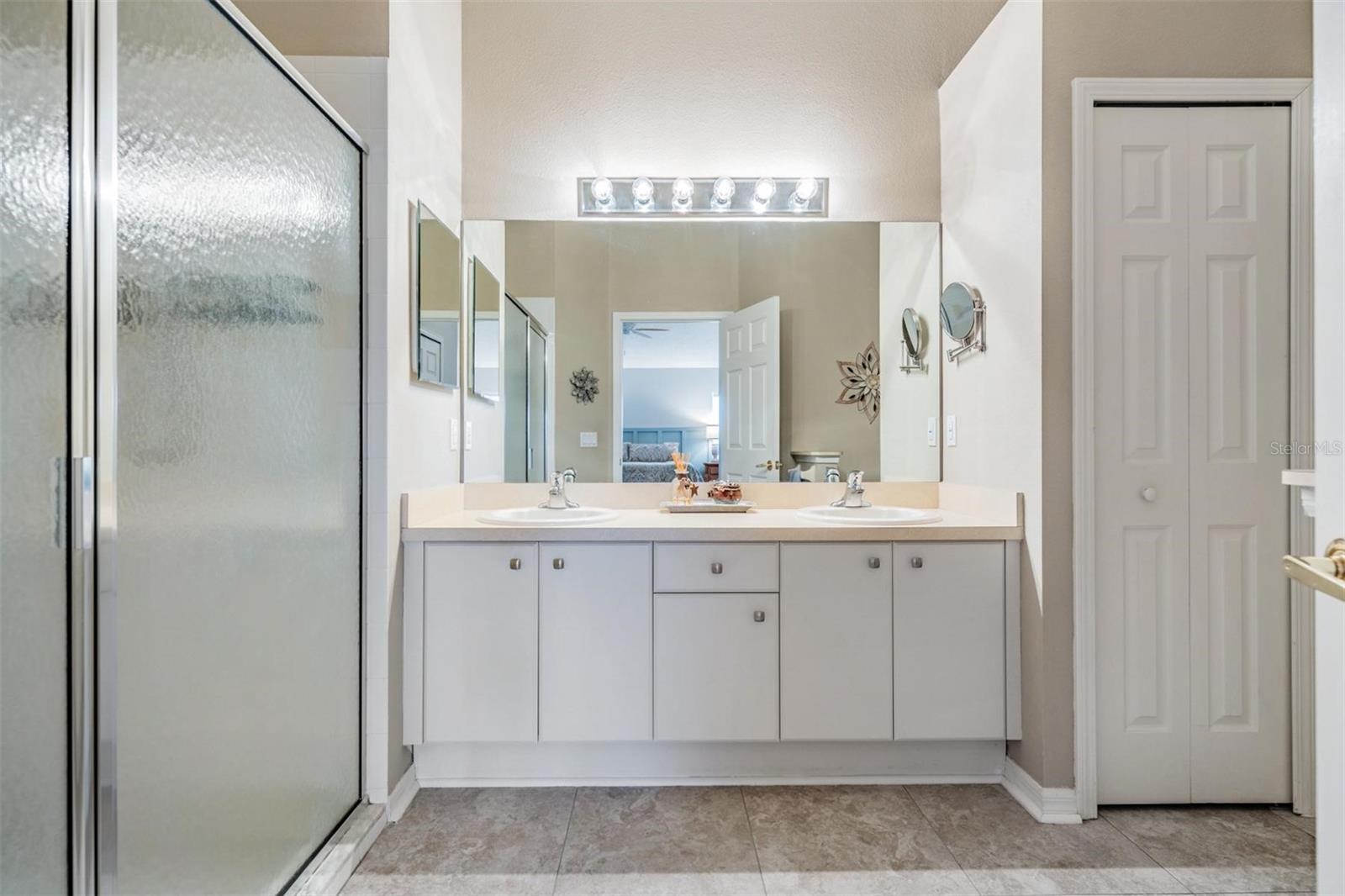 Master bathroom with double vanity providing additional storage space