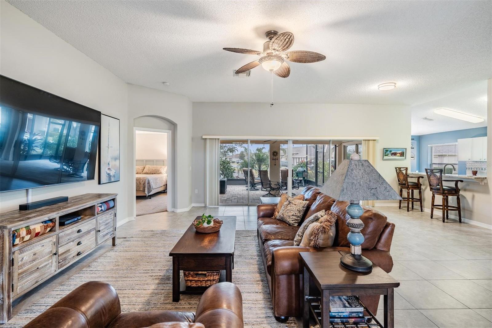 Open floorplan with high ceilings and arched doorway details