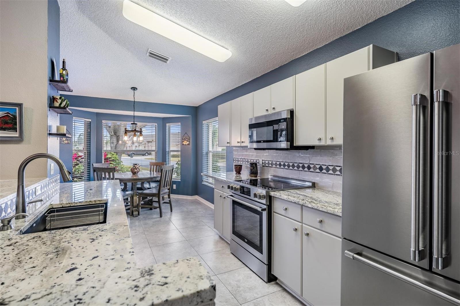 Updated kitchen with stone countertops and all stainless appliances