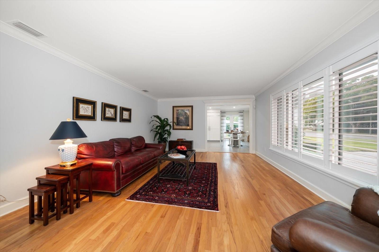 Spacious living room is bathed in natural light.