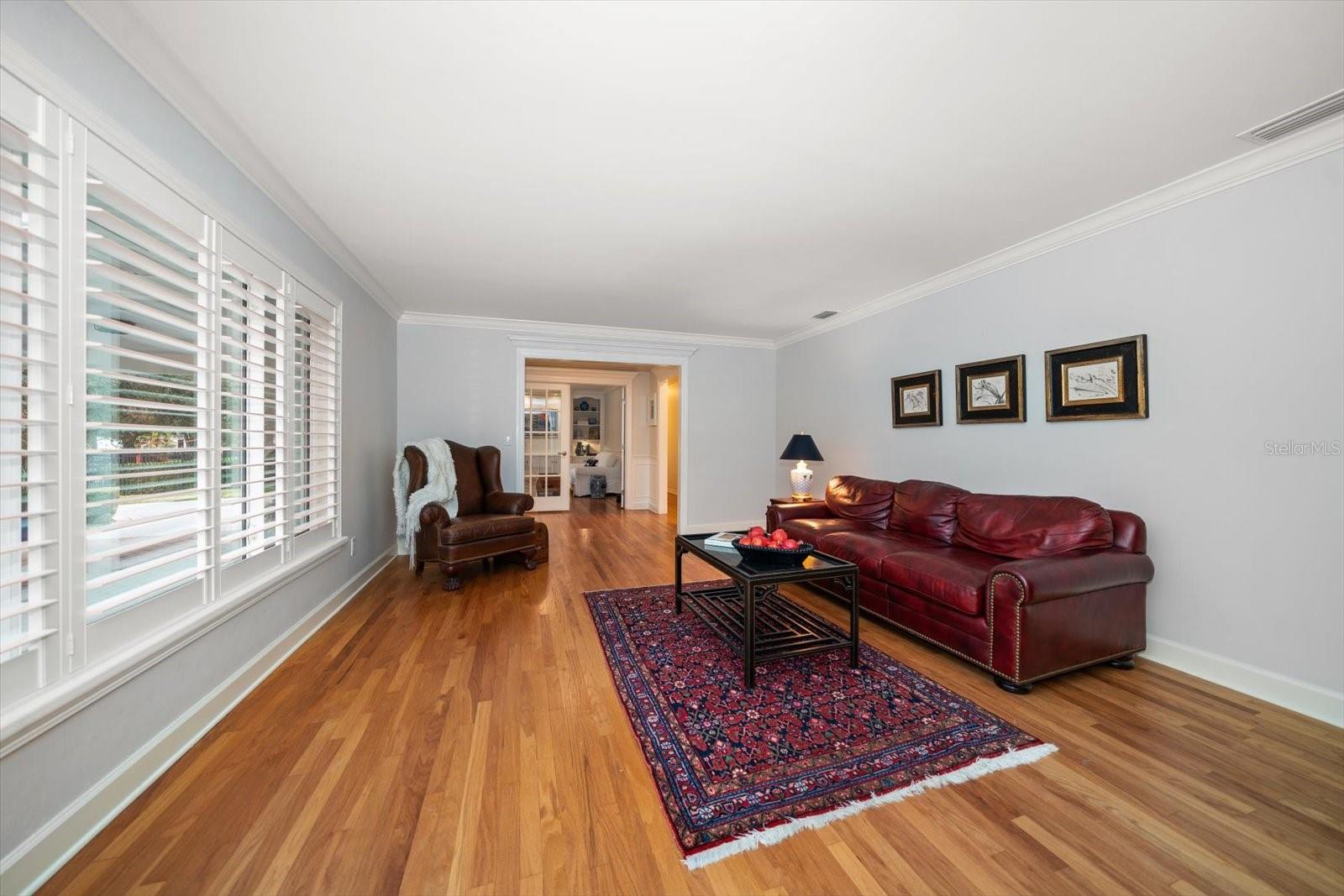 Living Room is light and airy with attractive wood flooring.