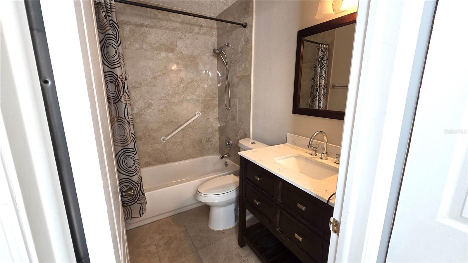 Beautifully updated bathroom with shower/tub combo