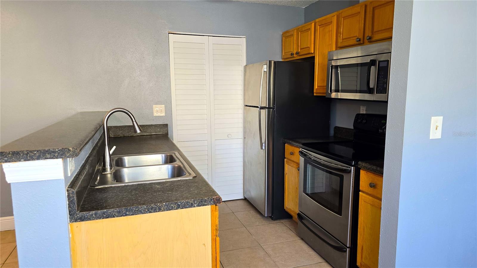 Adorable Kitchen.  The bifold doors takes you to the laundry room area.  All appliances stay.