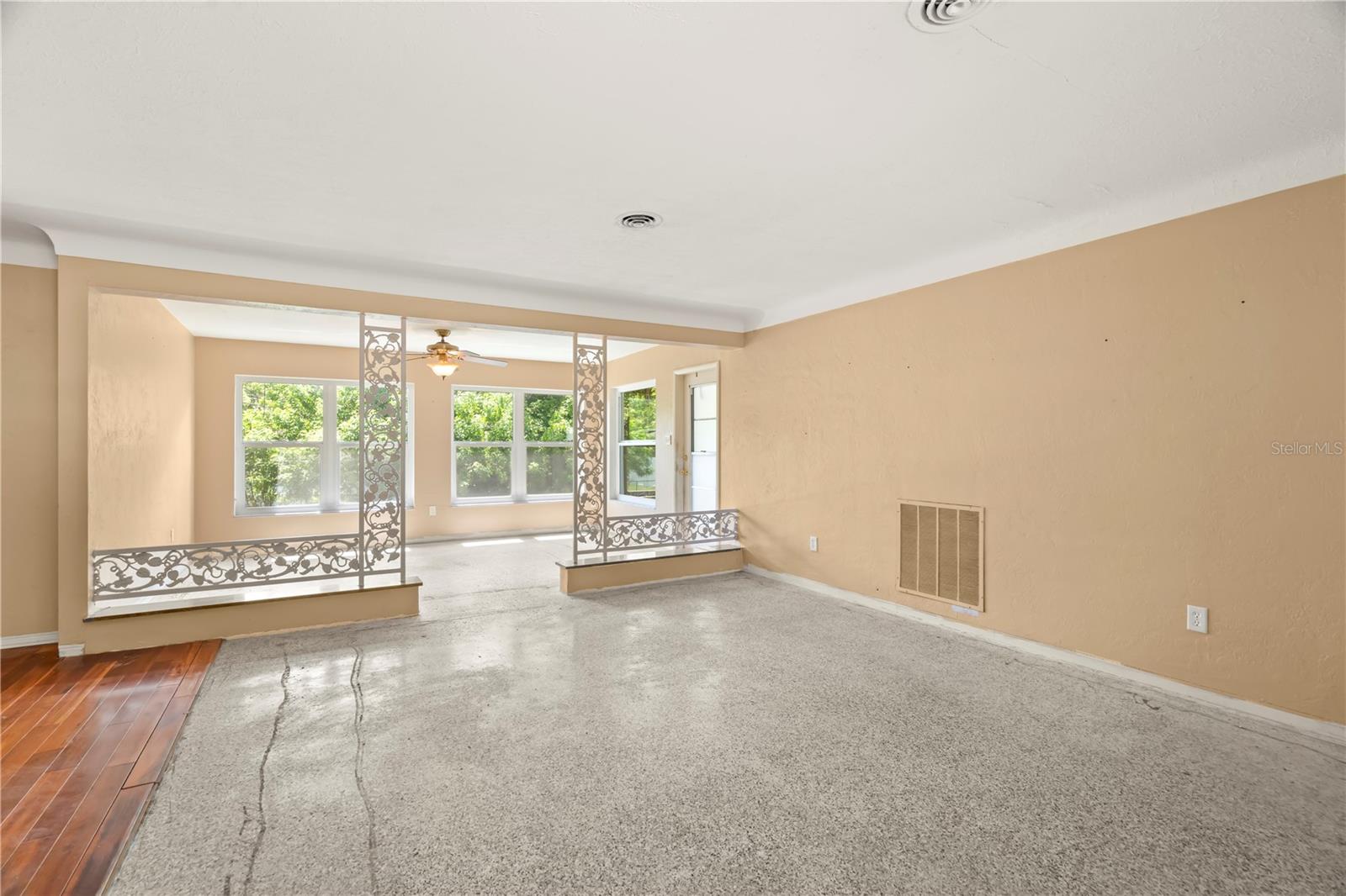 Living Room with elegant COVED CEILINGS! Carpets have been ripped up so you can install your own flooring or keep the terrazzo underneath