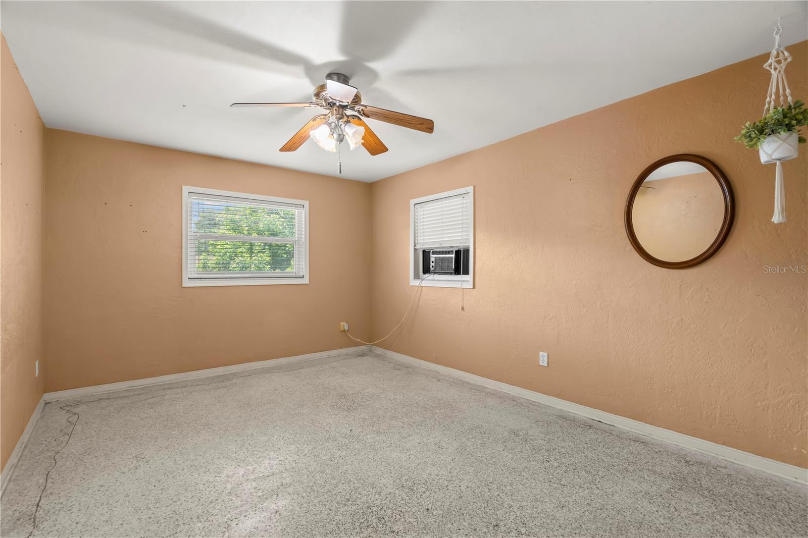 3rd bedroom has a ceiling fan. Carpets have been ripped up so you can install your own flooring or leave the terrazzo underneath