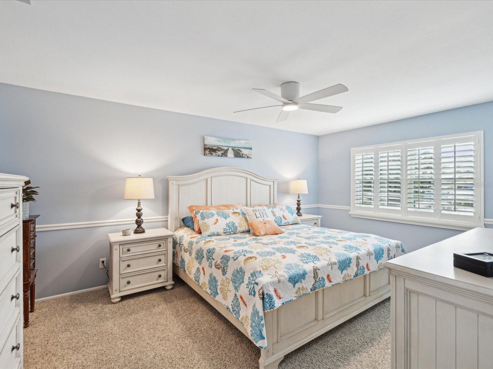 Master bedroom with 3 1/2 in wood shutters and updated fan