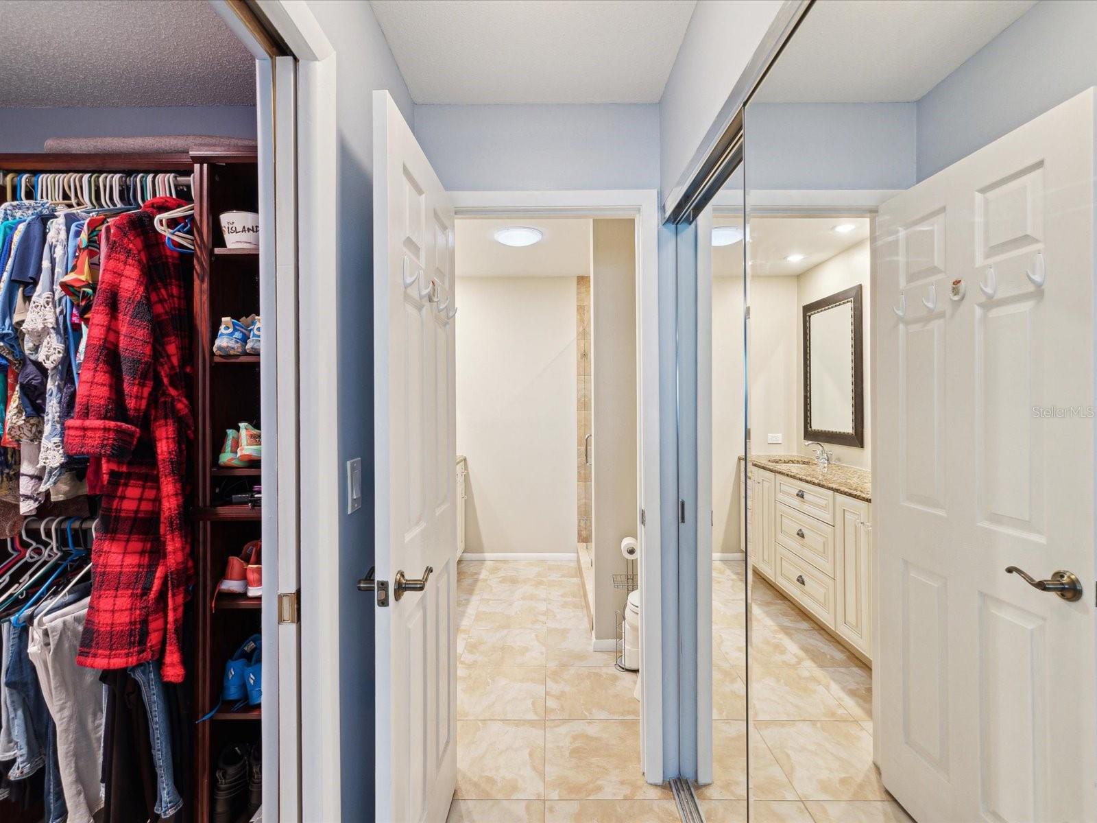 Entry to master bath with walk in closet to your left and large double closet to the right.