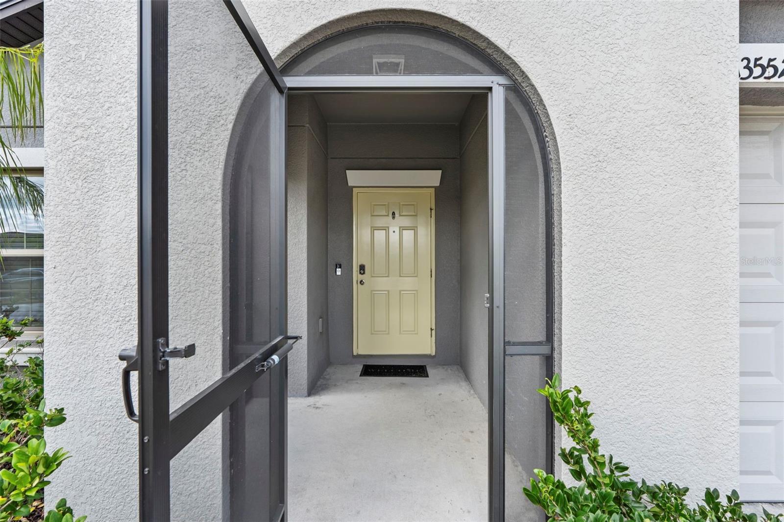 Screened in front porch to welcome visitors  13557 Willow Bluestar Lp, Riverview, FL 33579