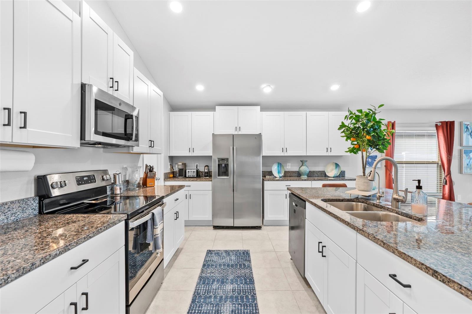 Stainless steel appliances throughout ceramic tiled kitchen.   13557 Willow Bluestar Lp, Riverview, FL 33579