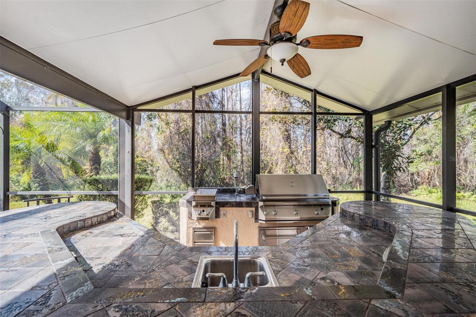 Custom bar and outdoor kitchen means the party's at your house!