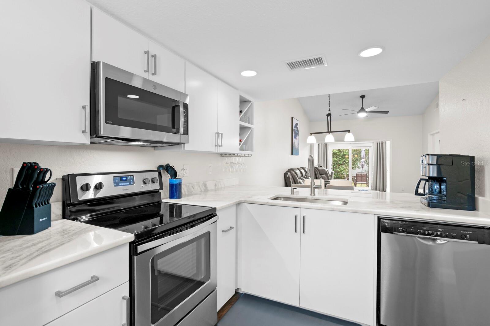 The kitchen includes custom solid wood, soft close cabinets