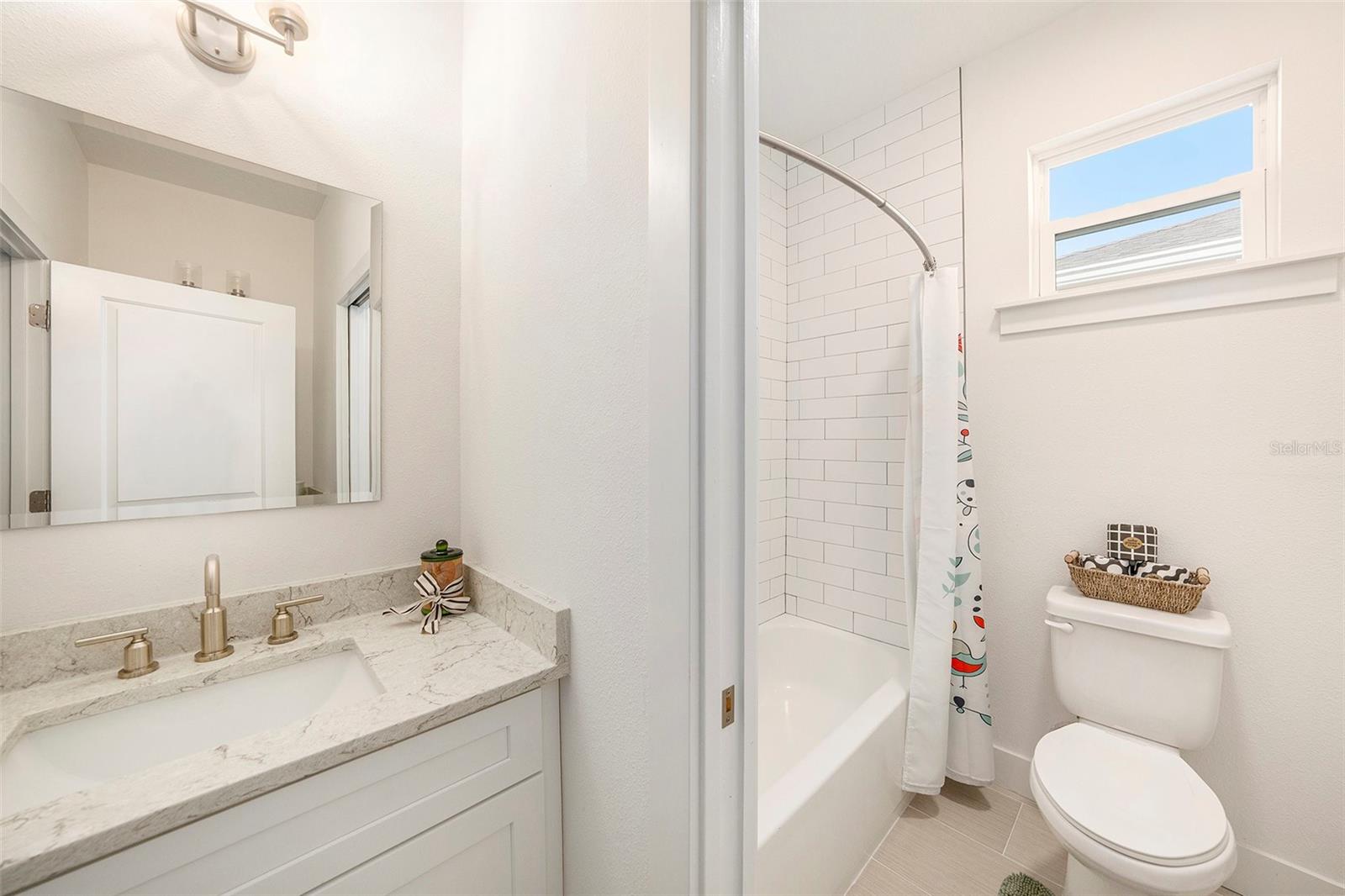 Guest Bath - tub surround tiles go up to ceiling.