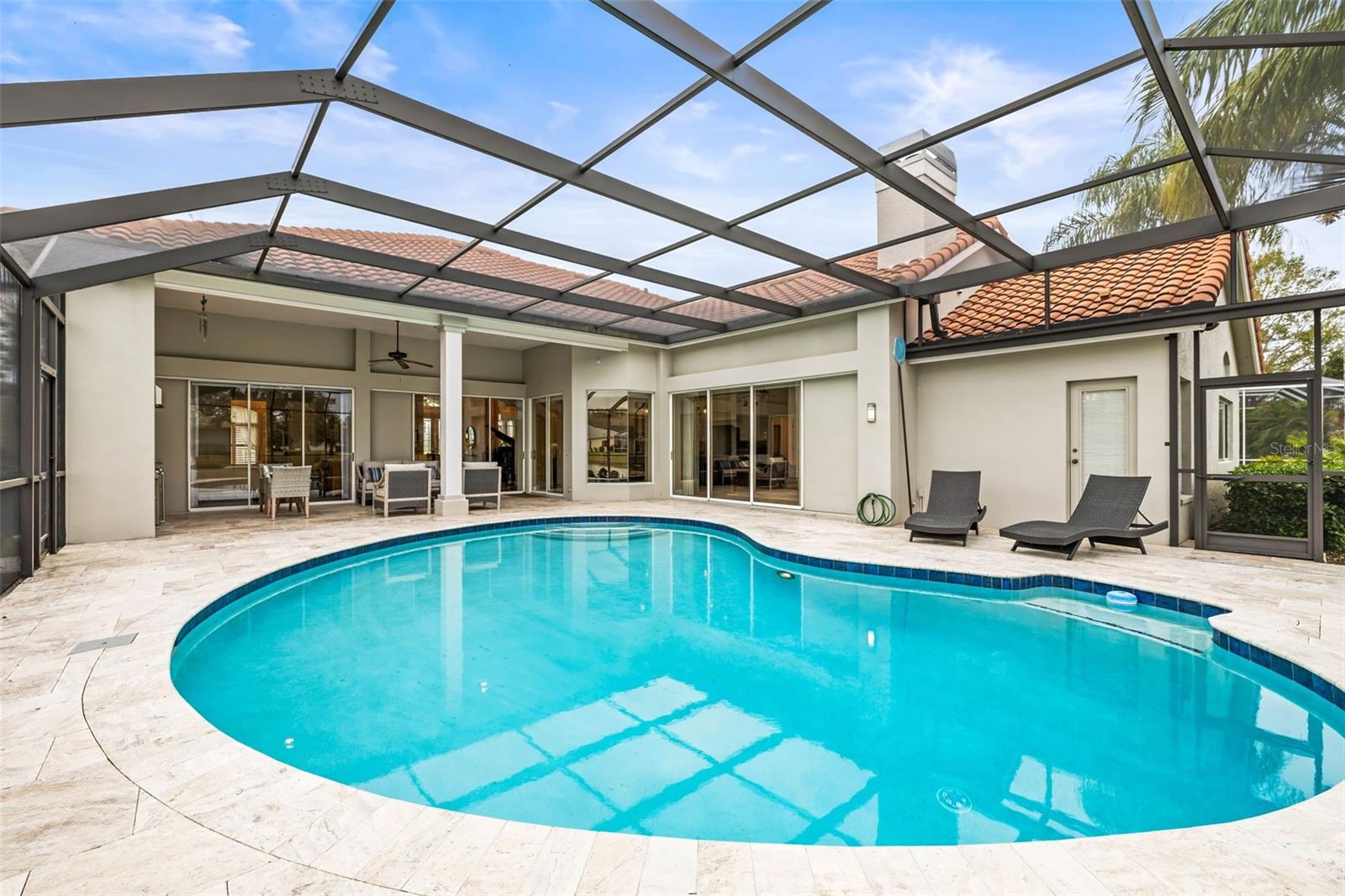 Saltwater pool with travertine pavers and NEW screen