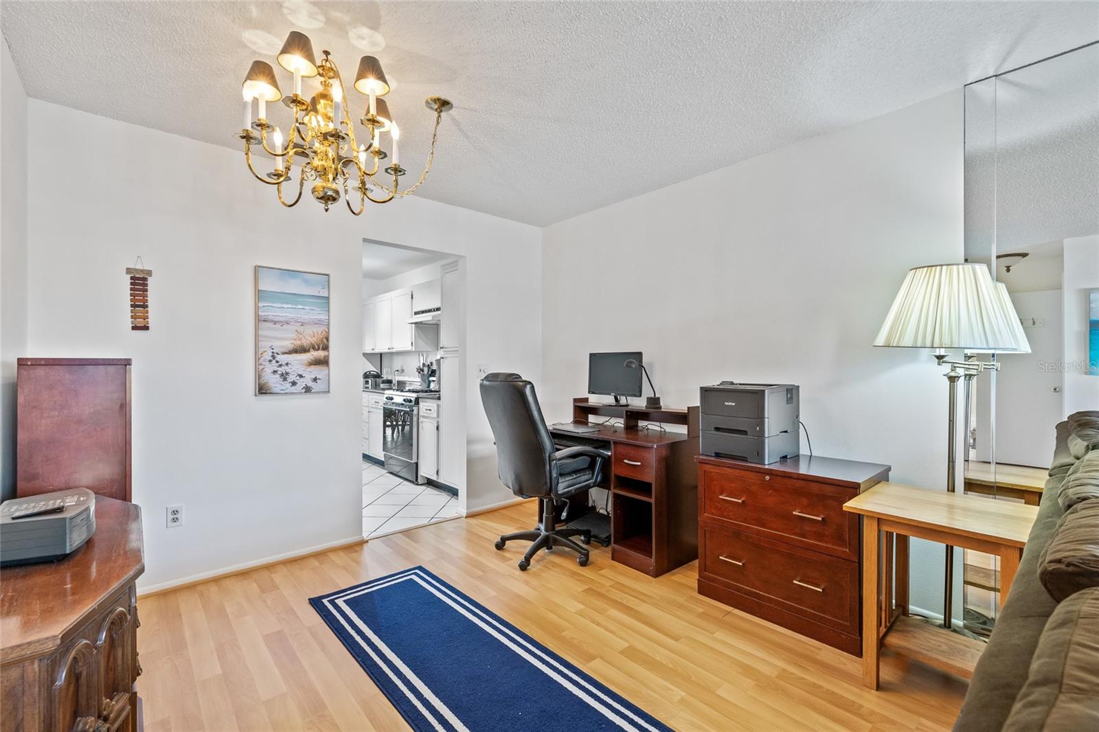 This flex area is part of the living room and leads to the kitchen. The owners use this space as an office.