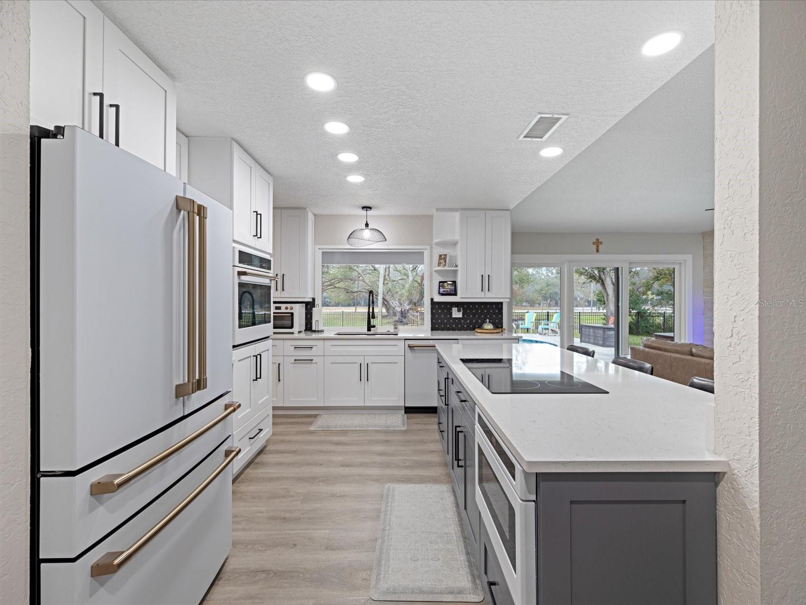 Kitchen with picture window overlooking pool