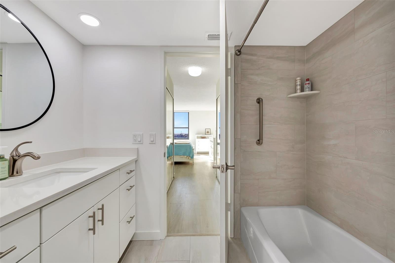 The ensuite bath with beautiful title and lots of counter space.