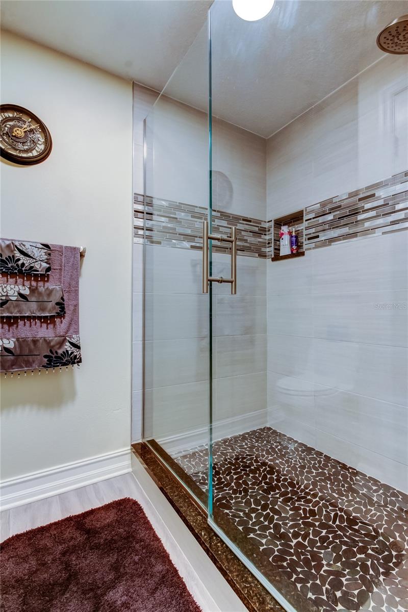 13. Step In FULLY UPDATED Shower is Tastefully Tiles.. w a Niche.. Listella for an Added Touch of Style, & Glass Door + Stable Partition too!