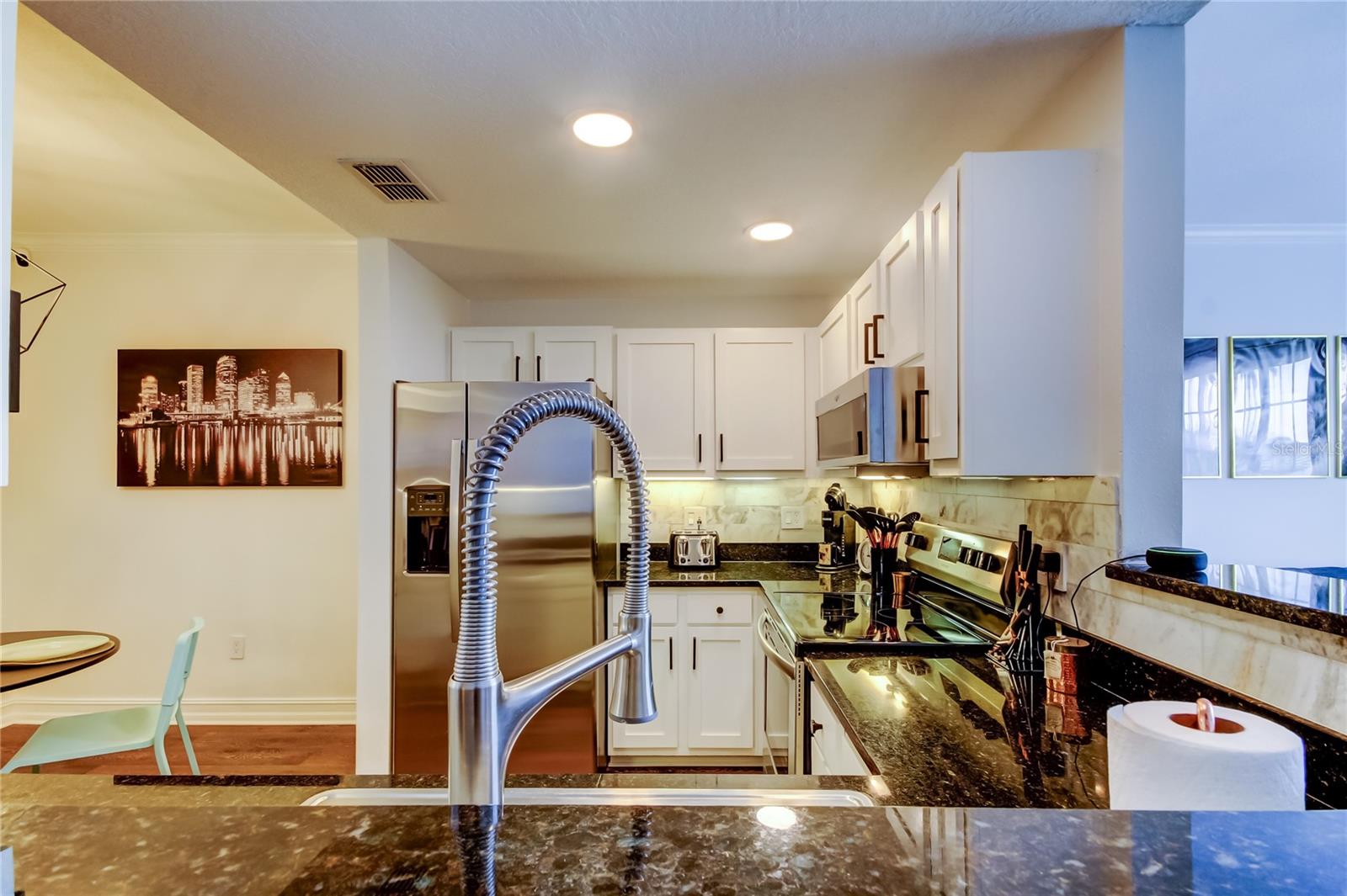 9. Peaking into a FULLY UPDATED Kitchen (7.9' x 10.2') from Over an Elongated Breakfast Bar..