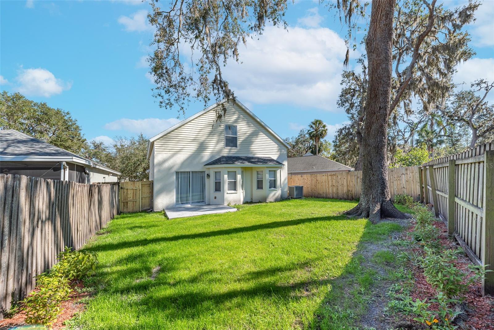 Open patio outback for outdoor entertaining in the fenced backyard, ideal for your furry friends.