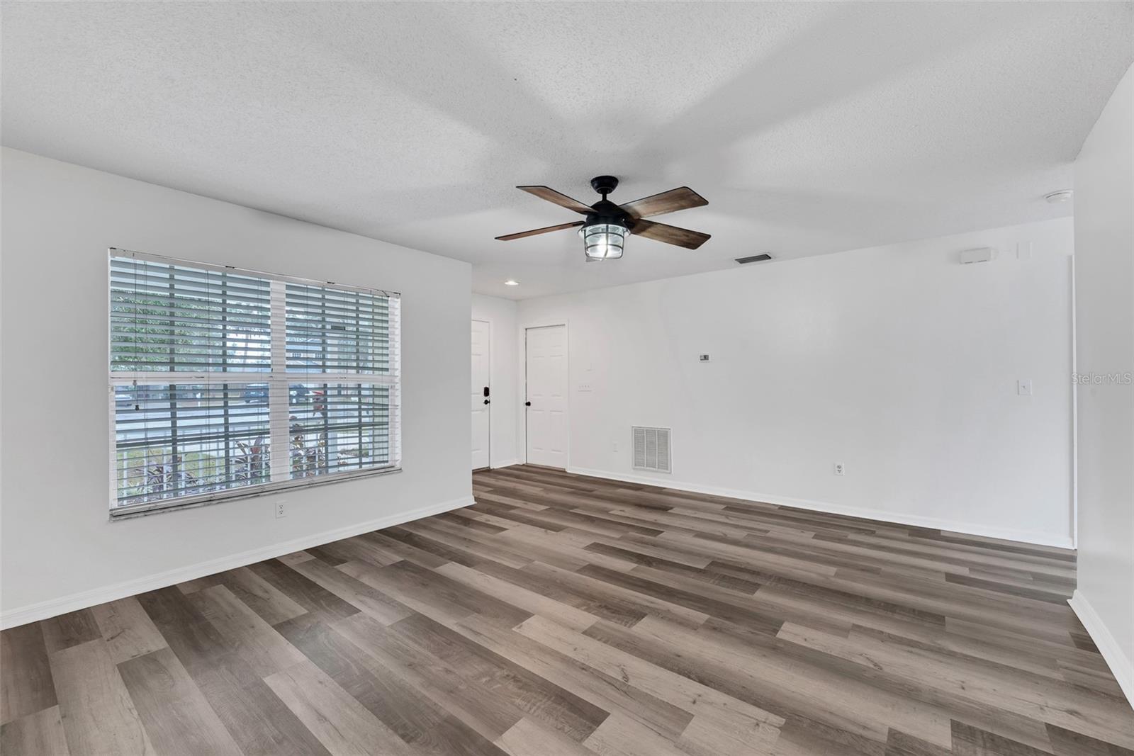 Plenty of natural light floods into this living room. Access to 1-car garage is located just inside the front door.