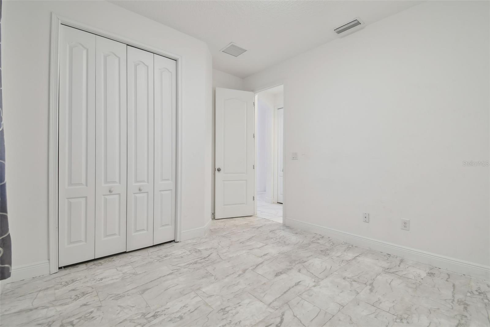 Bedroom 2 at the front of the home which is adjacent to the second bathroom.