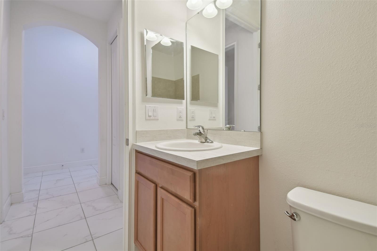 Second bathroom with vanity and tub, which is adjacent to the secondary bedrooms.