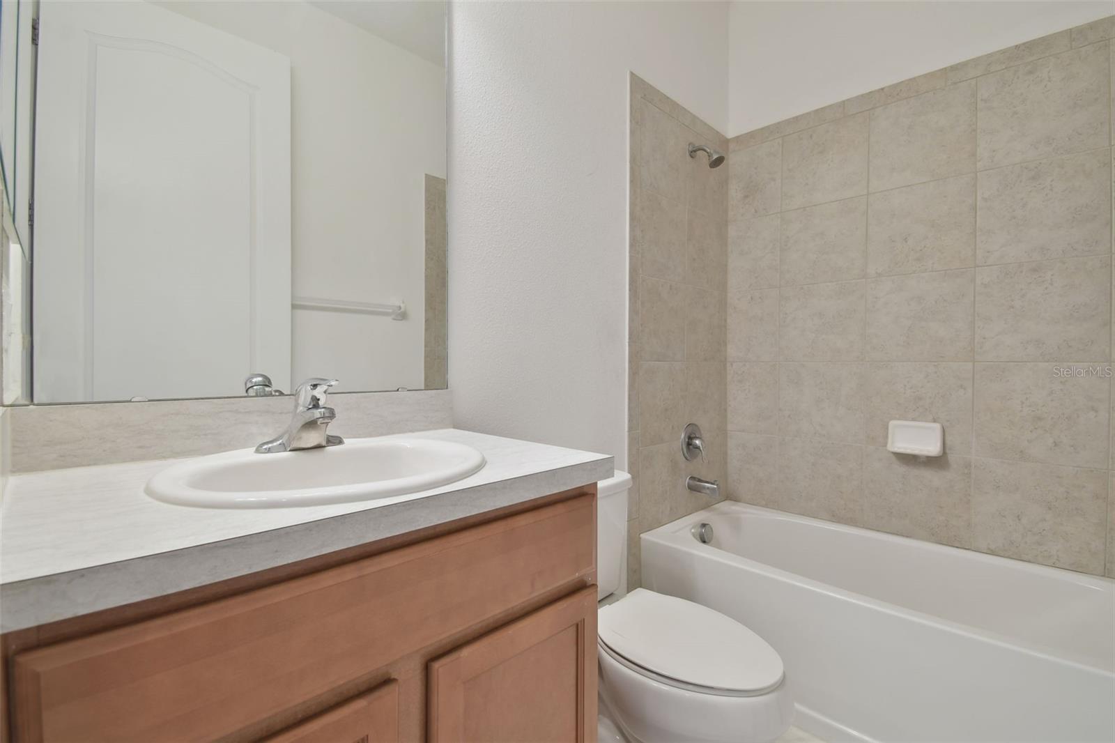 Secondary bathroom with vanity and tub.