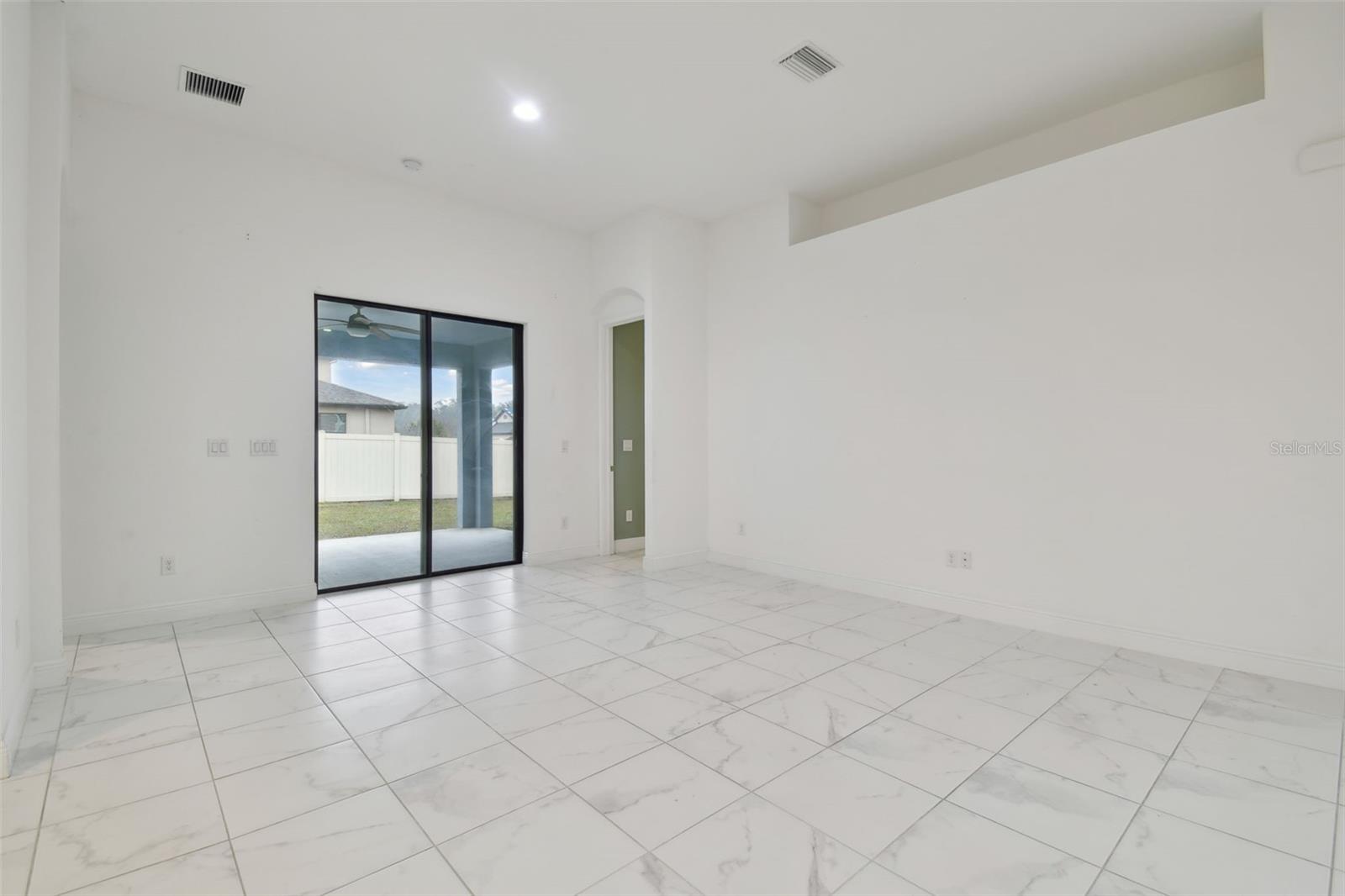 View towards the back covered lanai. Great space for family gatherings and entertaining.