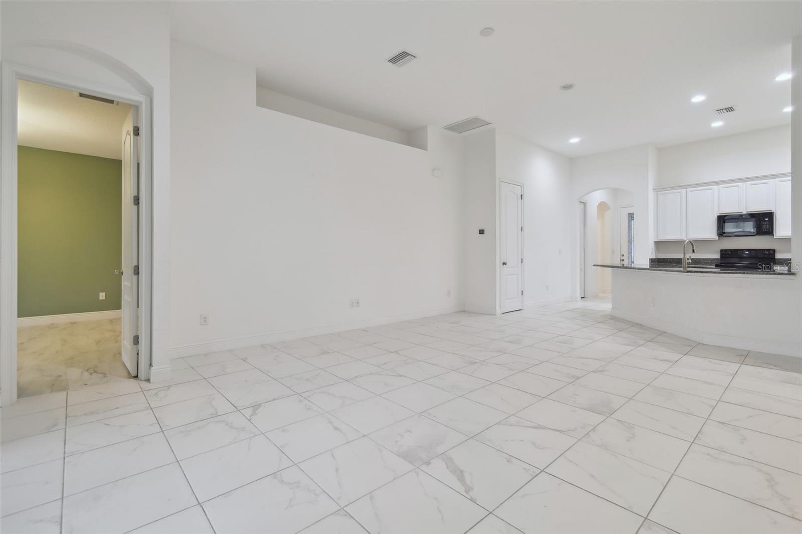 View from the living room to the Master.  Beautiful porcelain tiled floors in all the main areas.