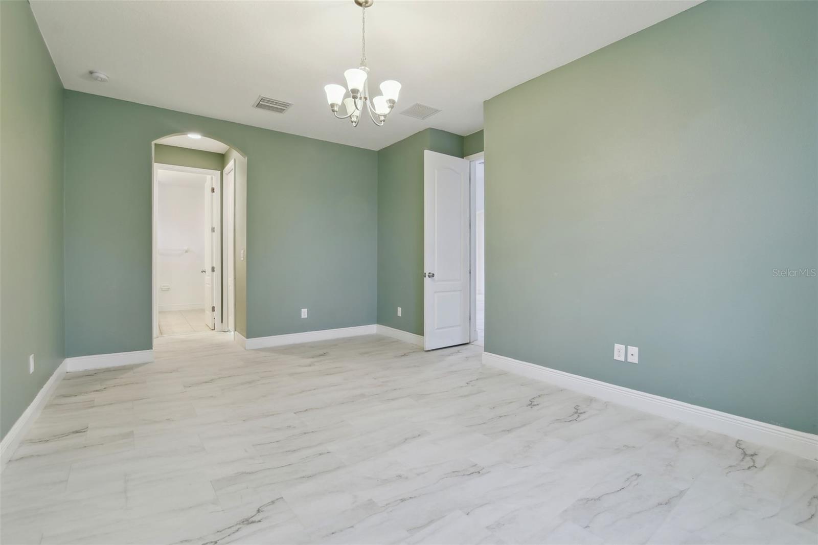 Master suite with an ensuite with vanity and walk-in shower.