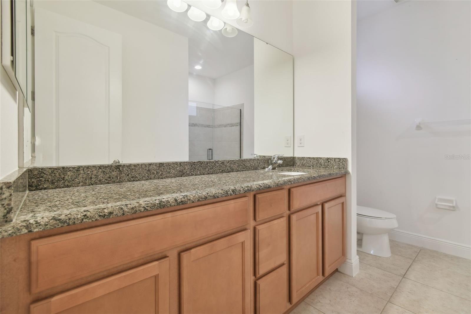 Master ensuite with single vanity with granite counter providing plenty of space.