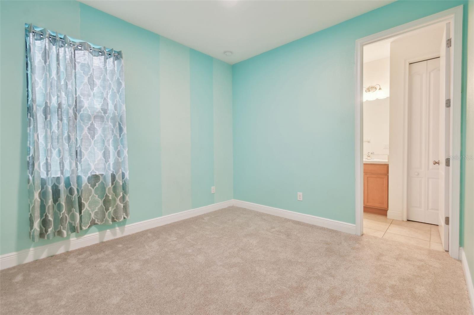 Bedroom 4 at the rear of the home.  Benefits from an ensuite with vanity and tub, storage closet and direct access out to the lanai.