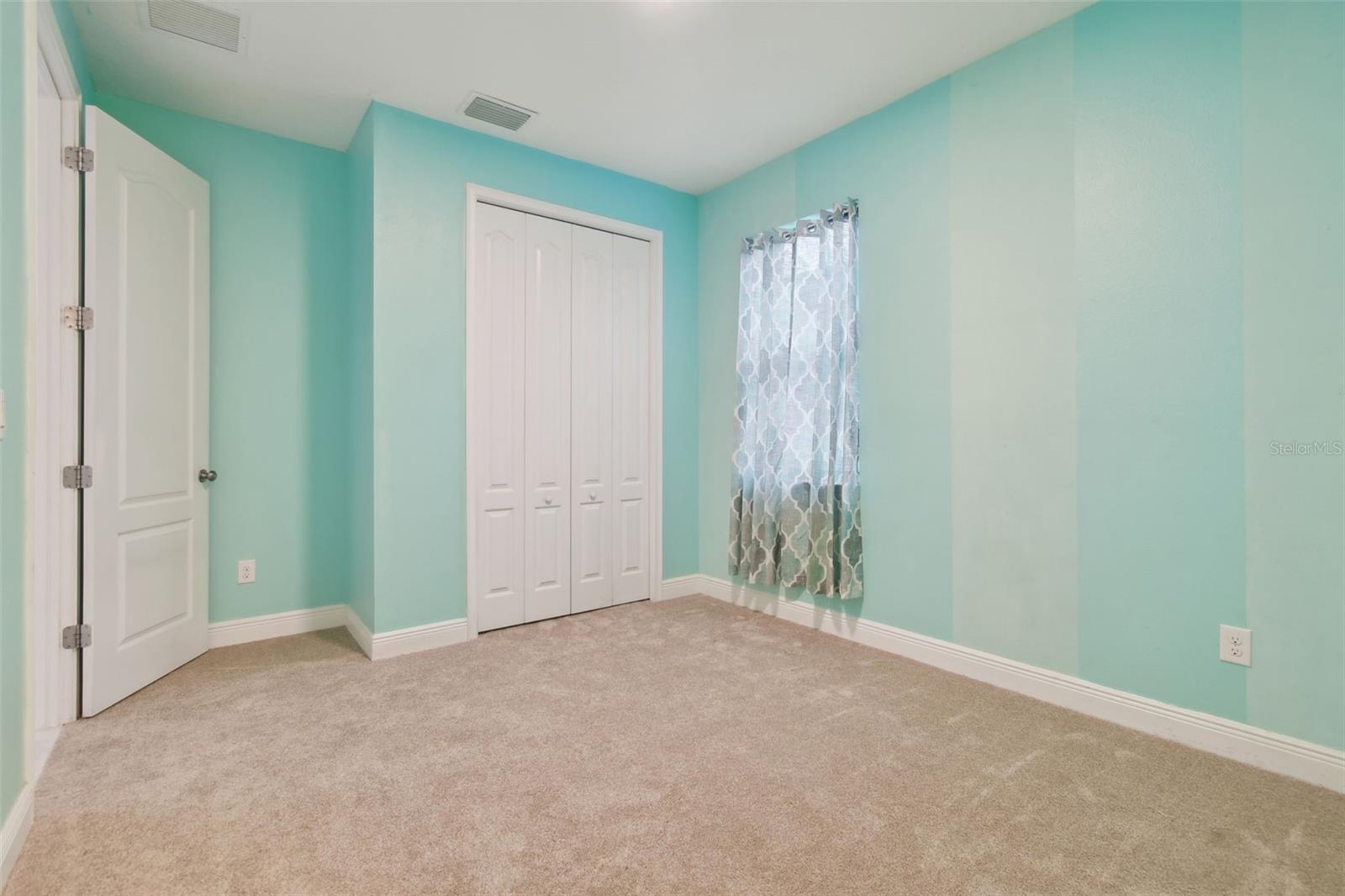 Bedroom 4 with newer updated carpet.  Access out to the living area.