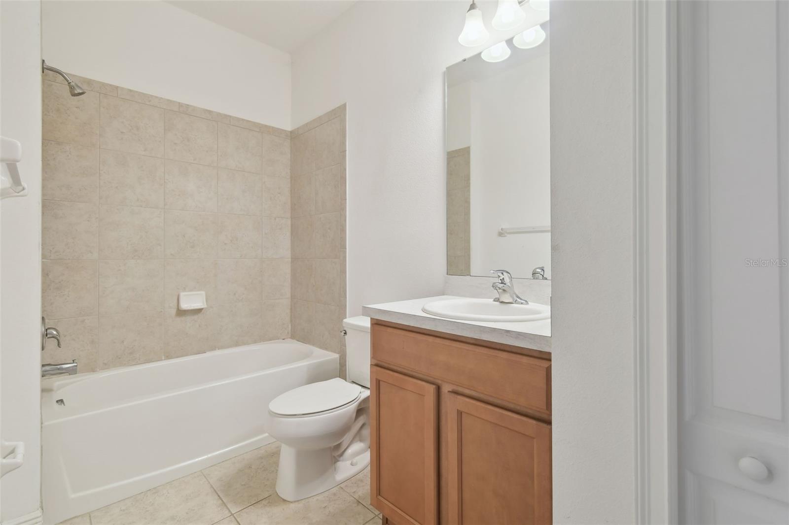 Bedroom 4 ensuite with tub and vanity.