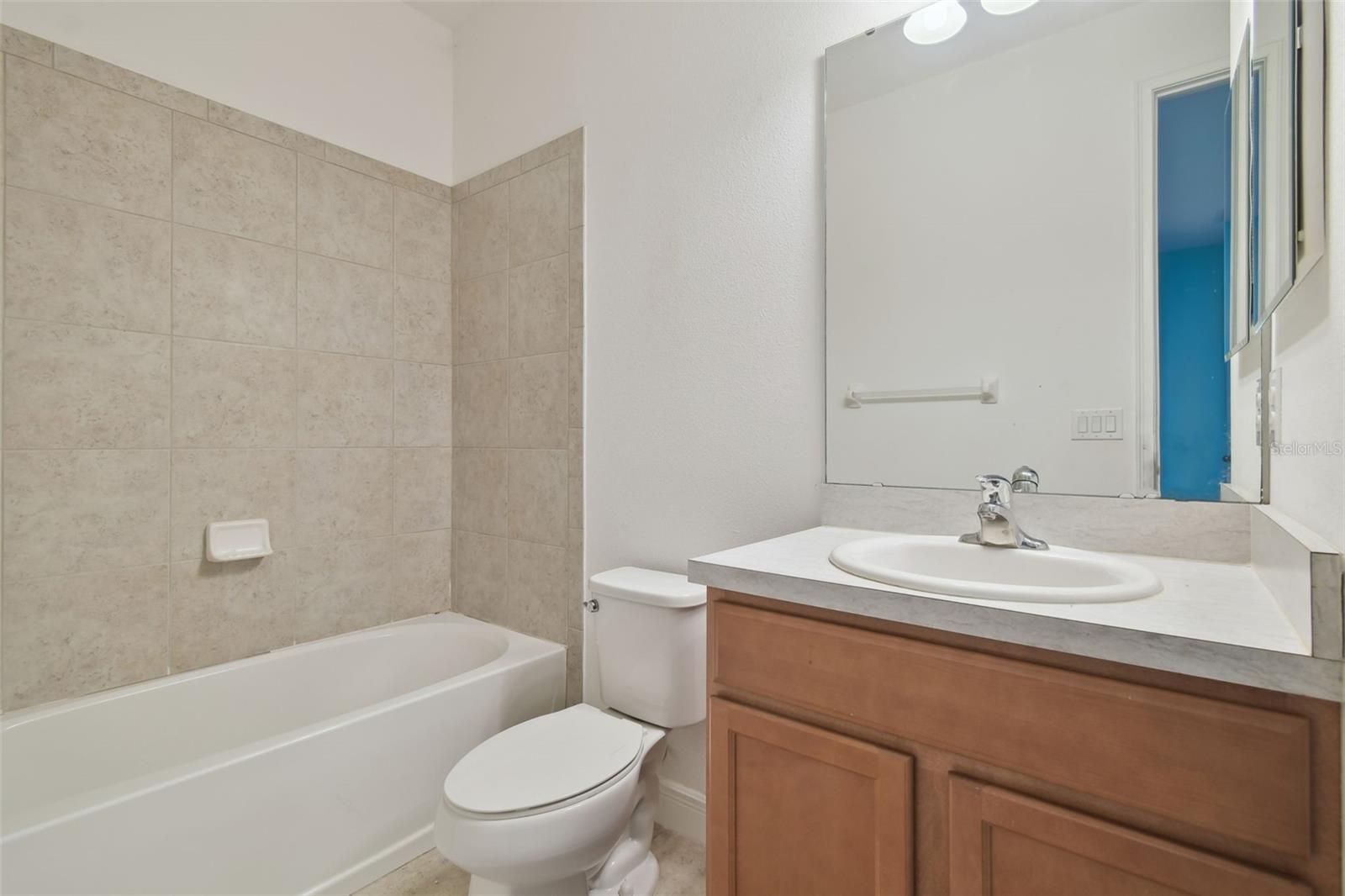 Bedroom 4 ensuite with tub and vanity.