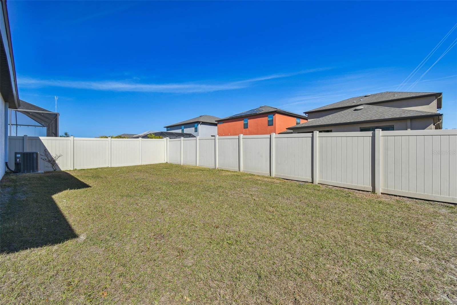 View of the spacious backyard.  Fenced on two sides.