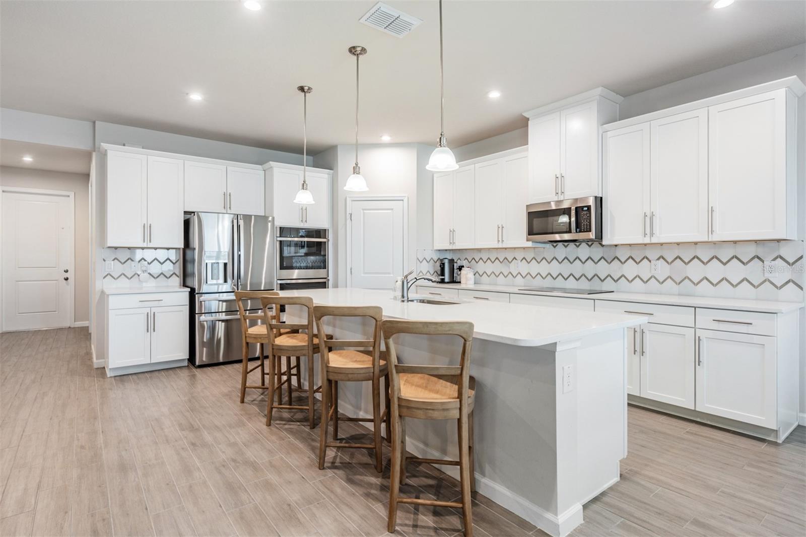 White quartz countertops & cabinets with crown molding