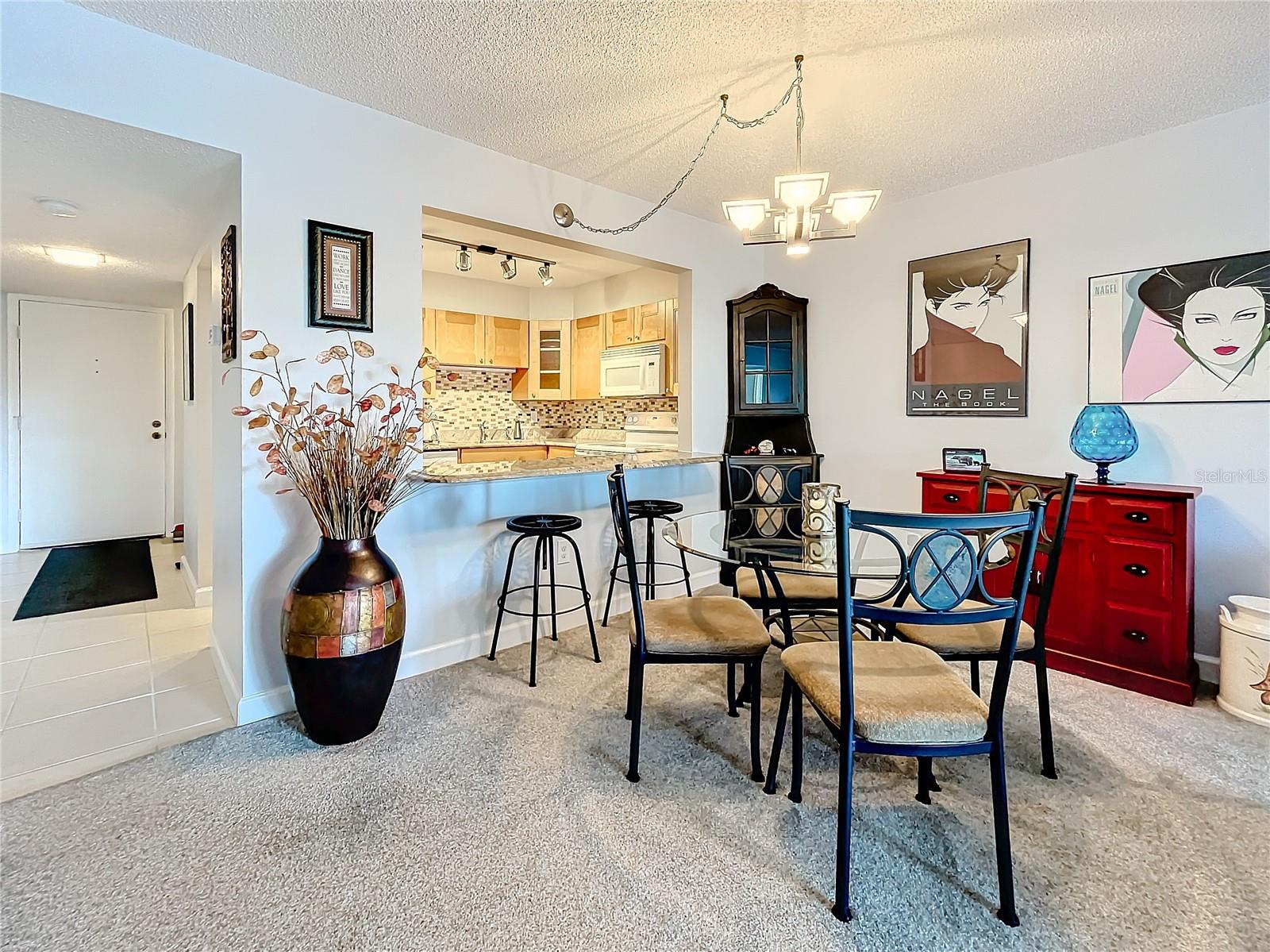 The kitchen offers a lovely backsplash and with nice cabinets.