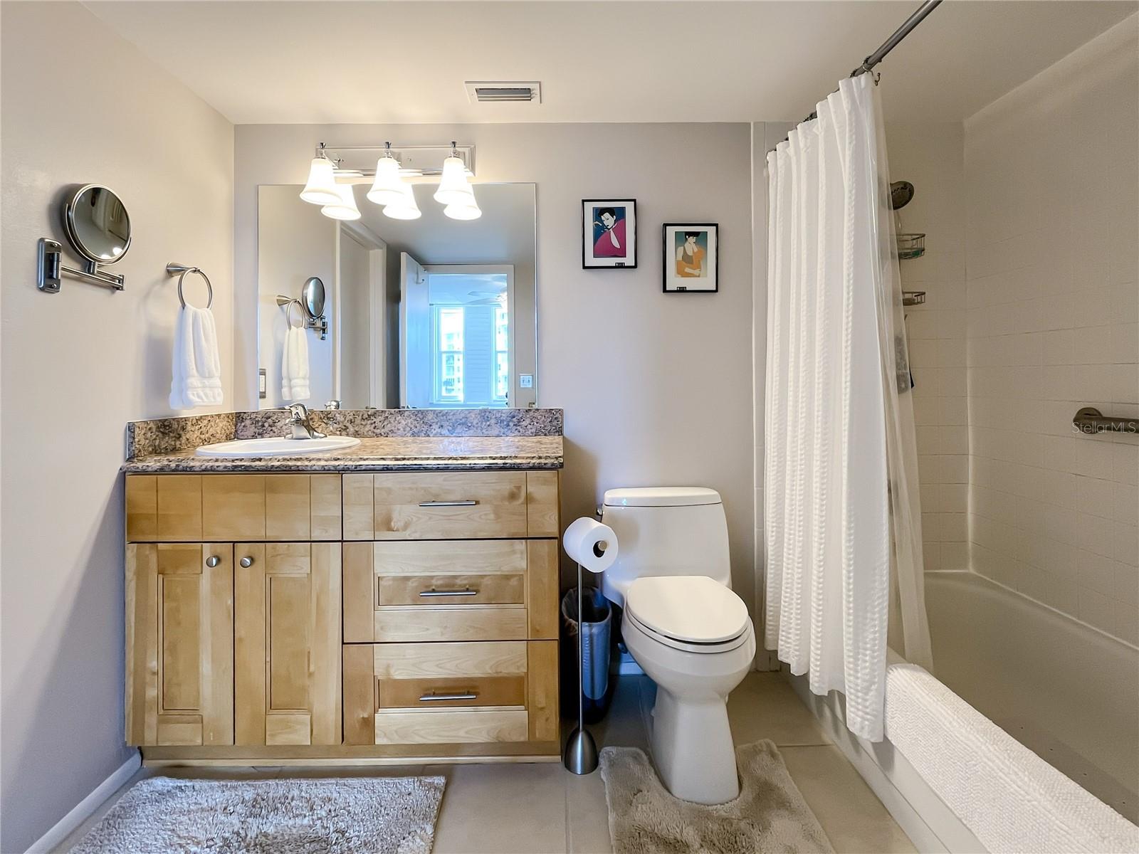 The half bath serves as the guest bath and has a stackable washer and dryer in the closet.