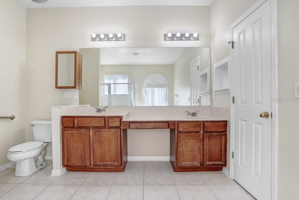 Primary Bathroom with dual sink vanity, garden tub and walk in shower