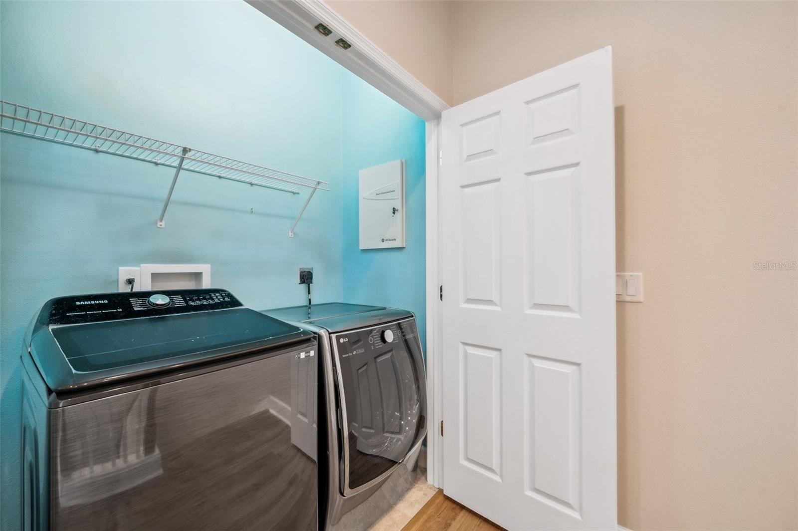 Laundry Room upstairs with built-in shelving.