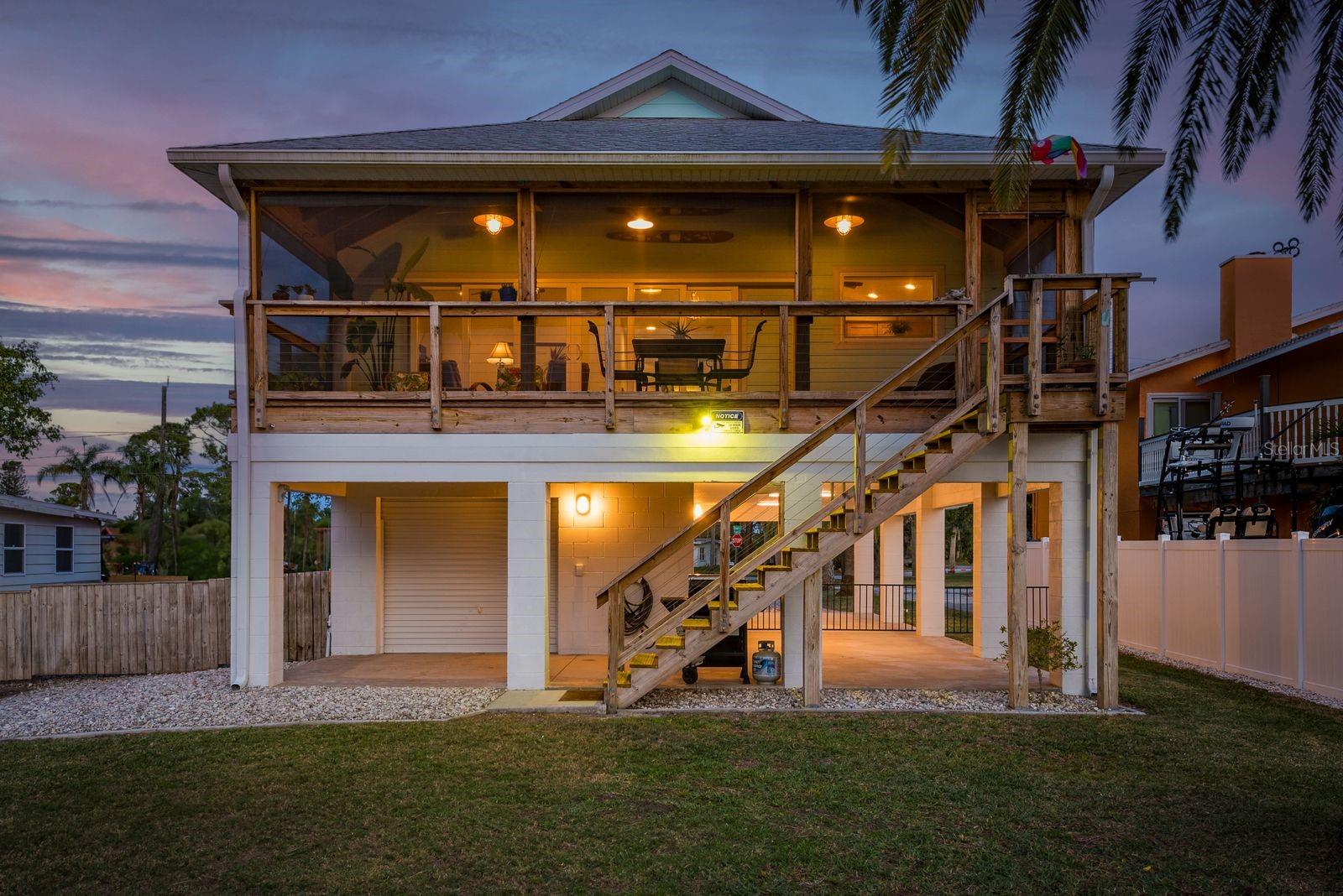 Rearview of the house from the water at Twilight