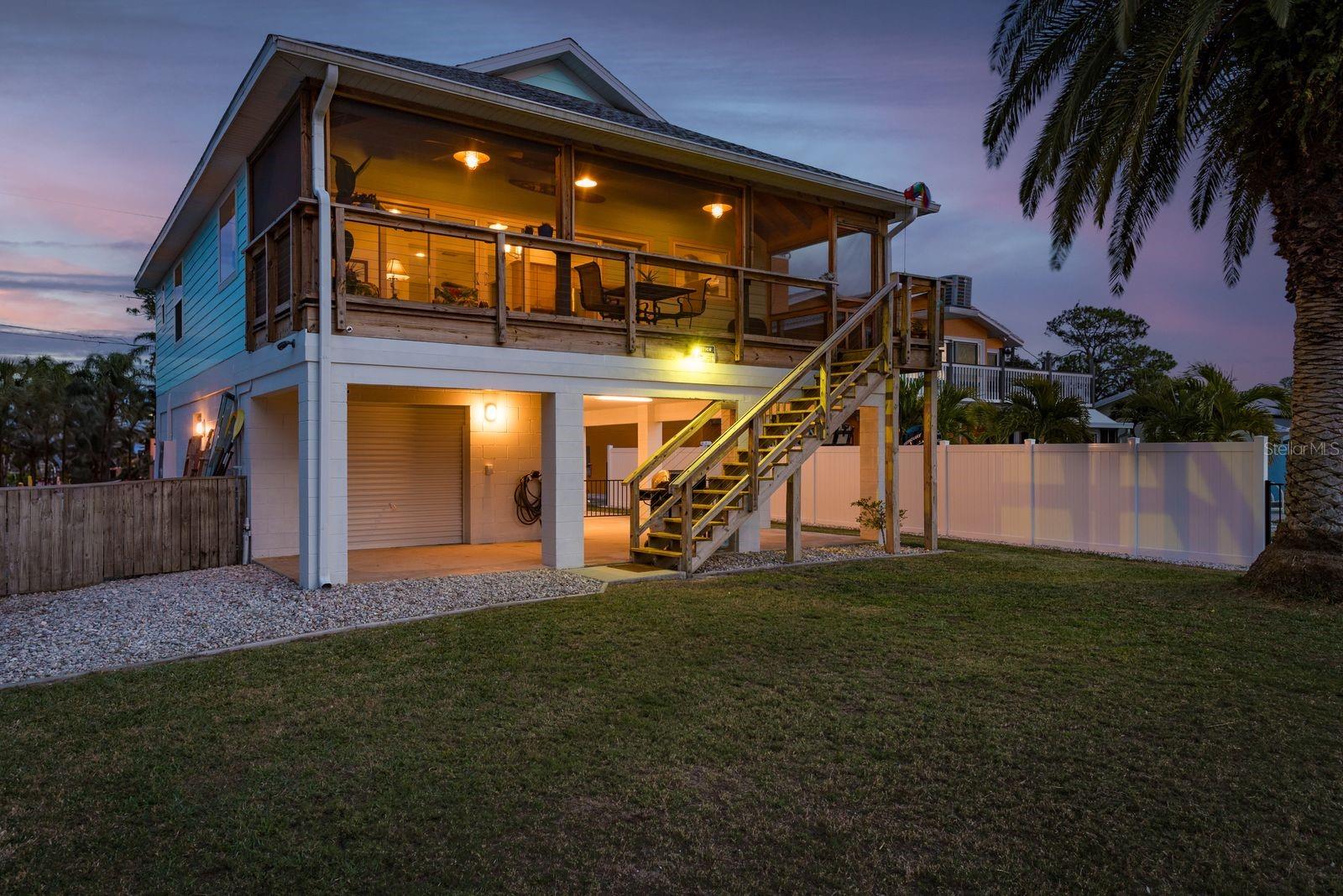 Angled Rearview of the house from the water at Twilight