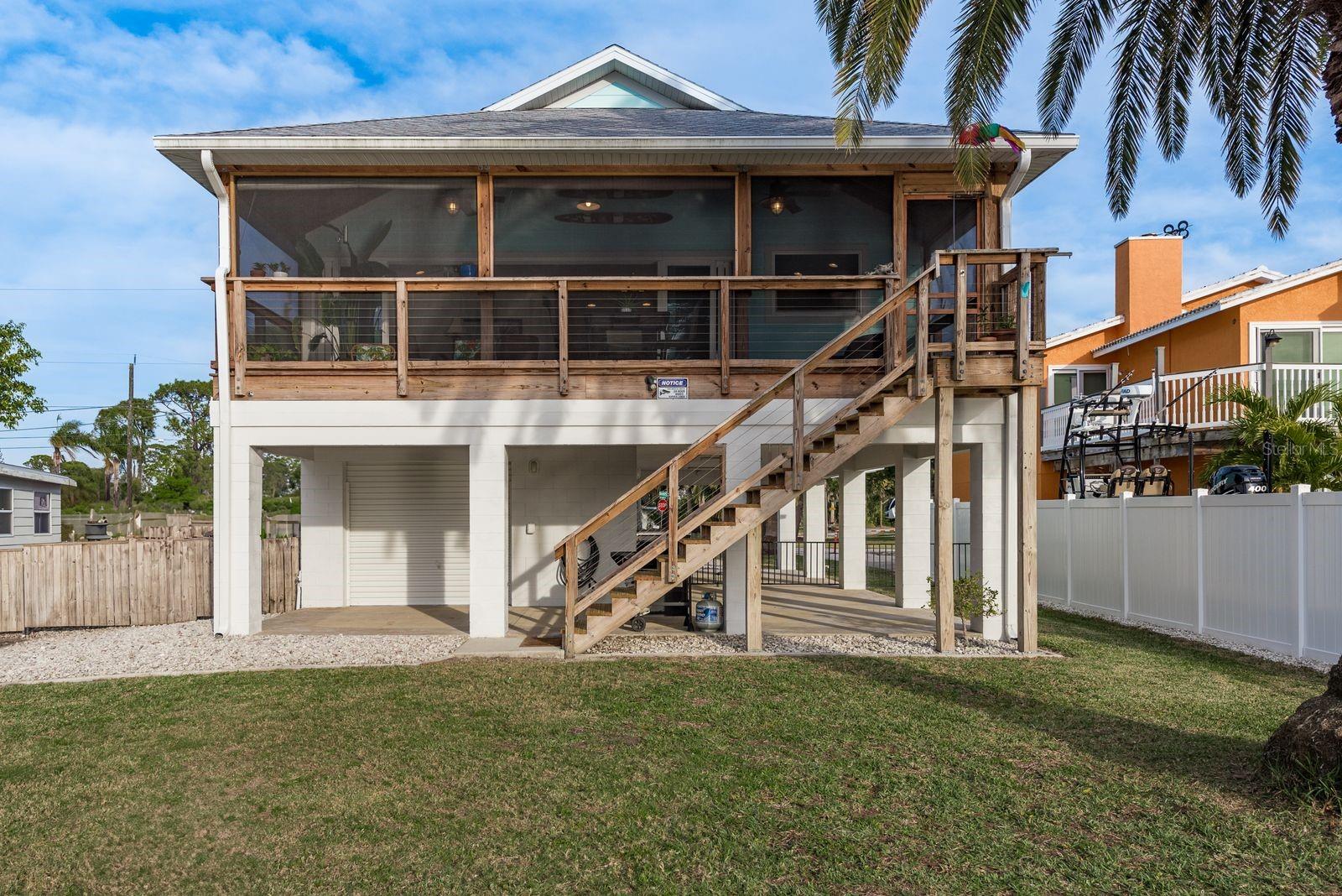 Rearview of the home features screened in patio