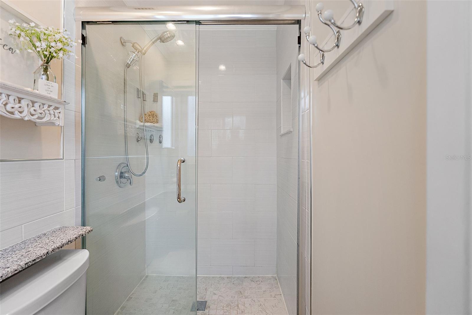 Remodeled shower - glass doors - cubby