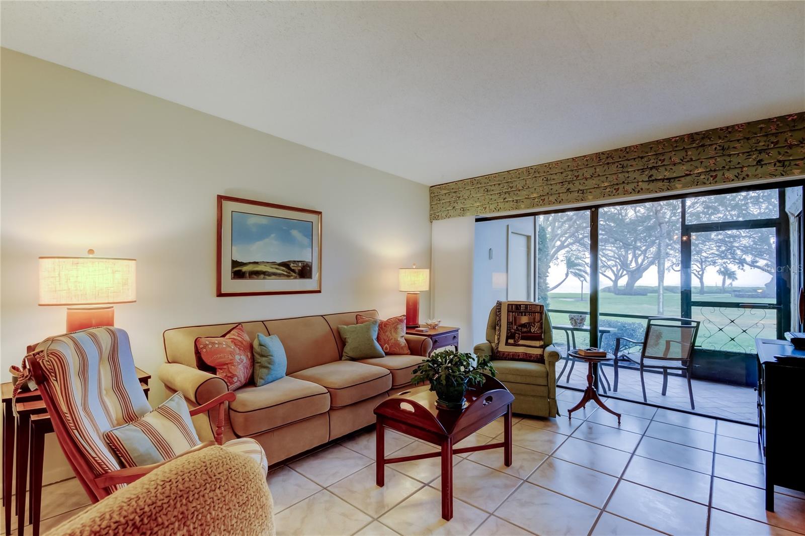 Living Room looks over screened patio with water views