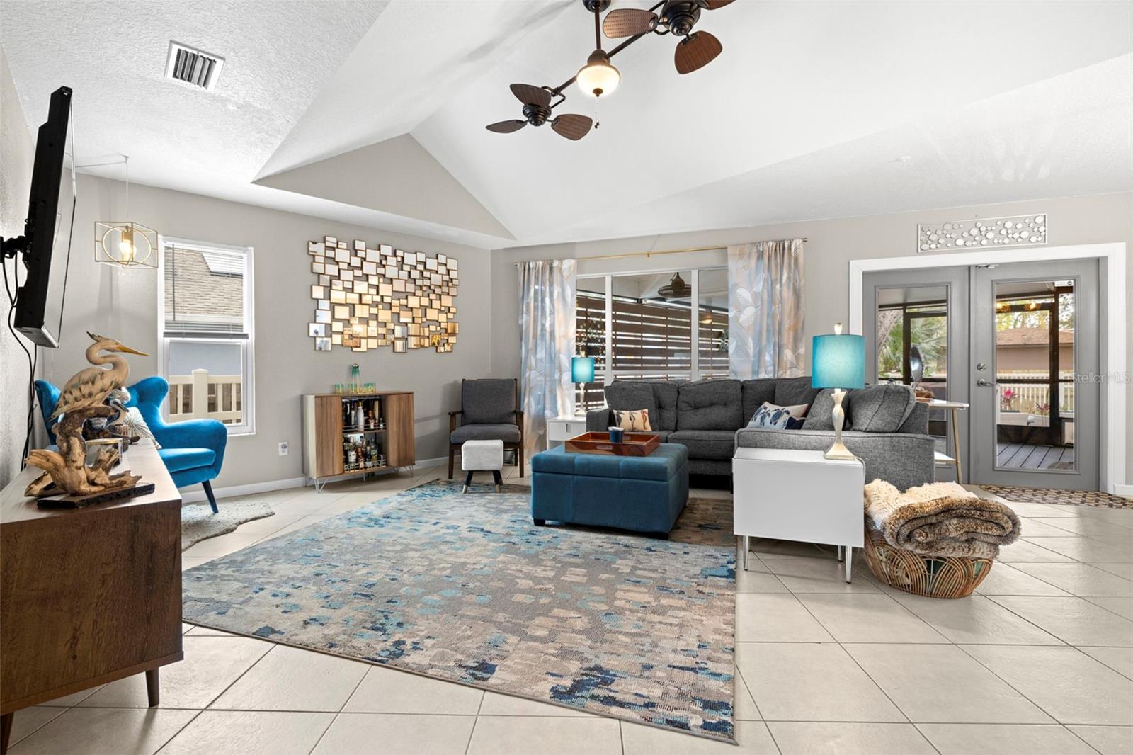 Living room with high ceilings and beautiful fans